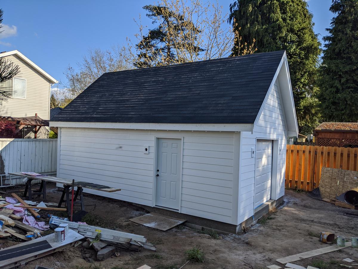 New detached garage with white lap siding