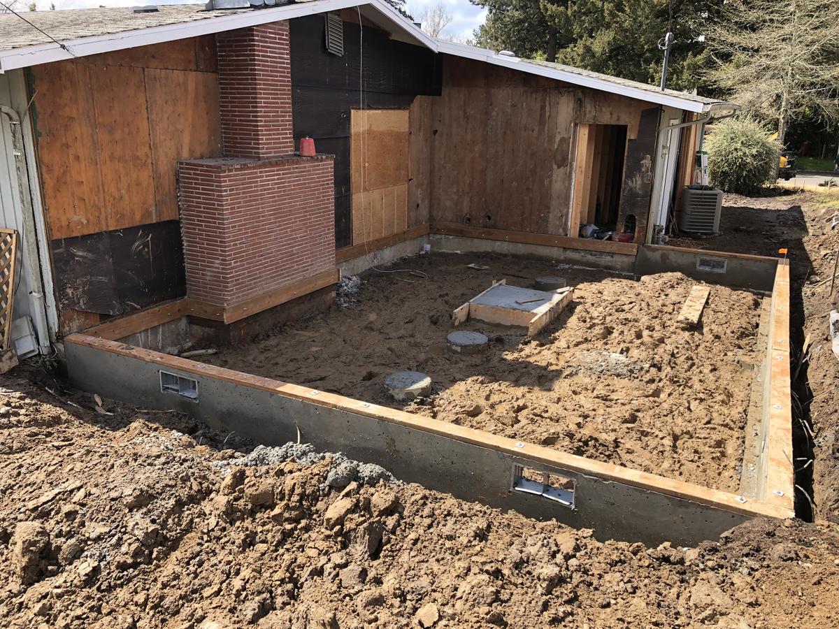 Excavated footprint and formed footings for a Portland house addition