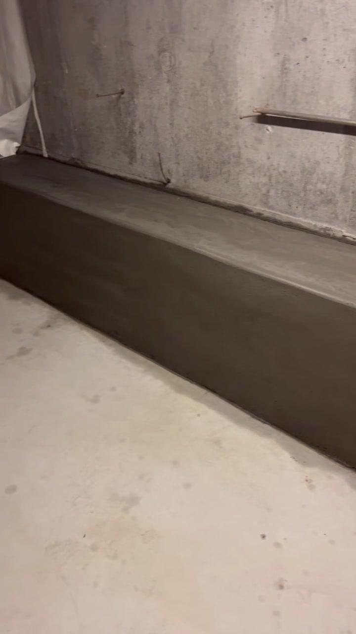 Smooth formed concrete ledge at the base of a basement wall, Portland-area repair