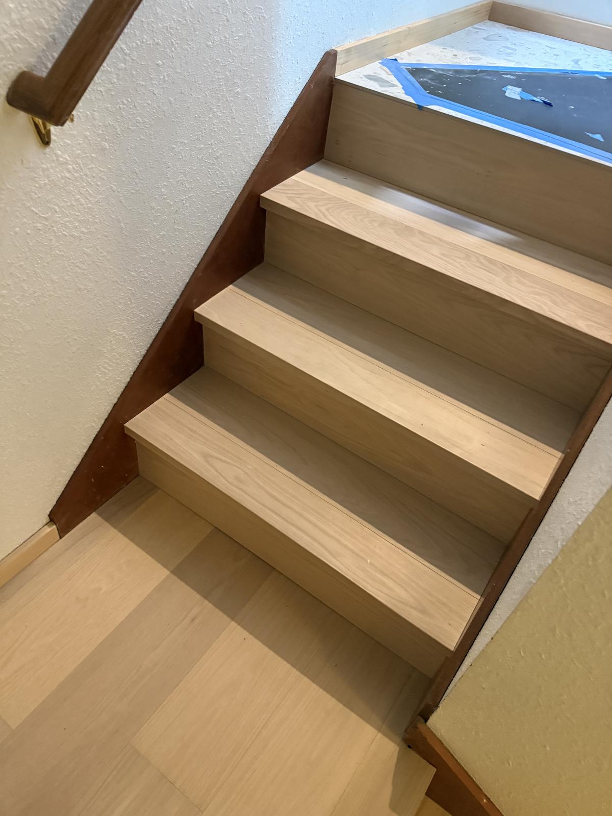 Light wood-tone stair treads with matching nosing from a Portland-area flooring install