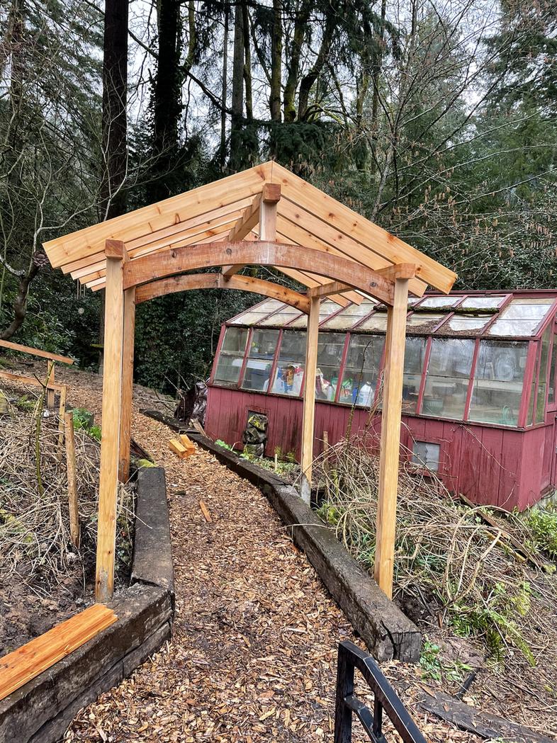 Cedar garden arch built over a garden path in Portland