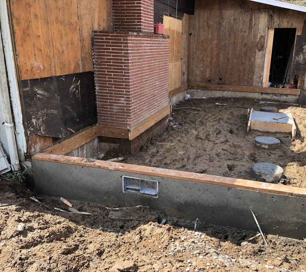 New concrete stem wall foundation with crawlspace vent for a Portland house addition