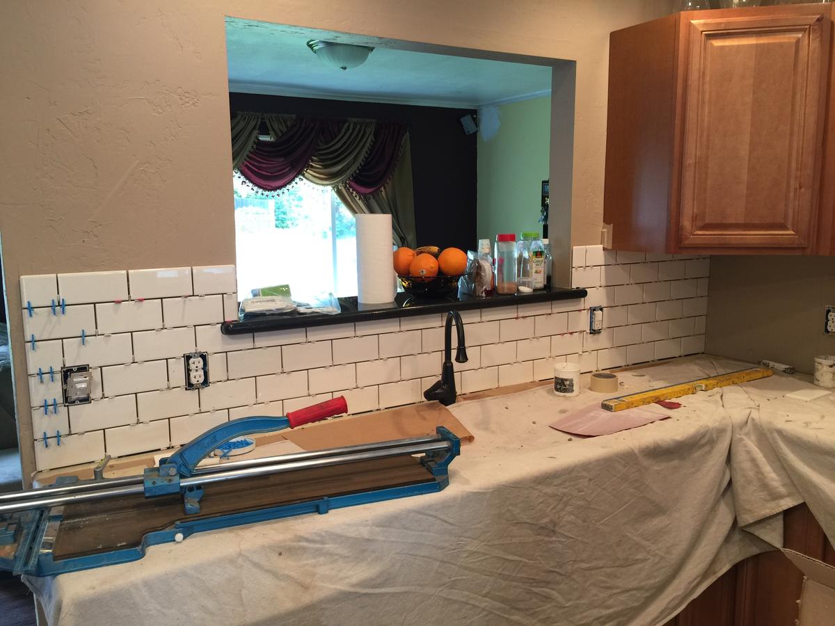 Subway tile backsplash being installed during a Portland kitchen remodel