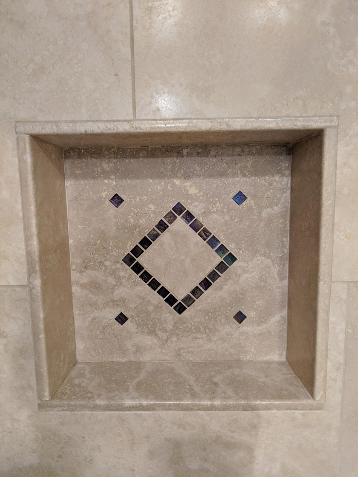 Recessed tile shower niche with a mosaic diamond inlay in a Portland bathroom remodel