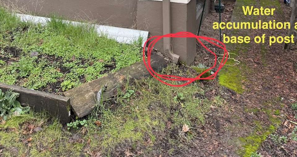 Structural assessment of a front porch, marking water collecting at the base of a support post