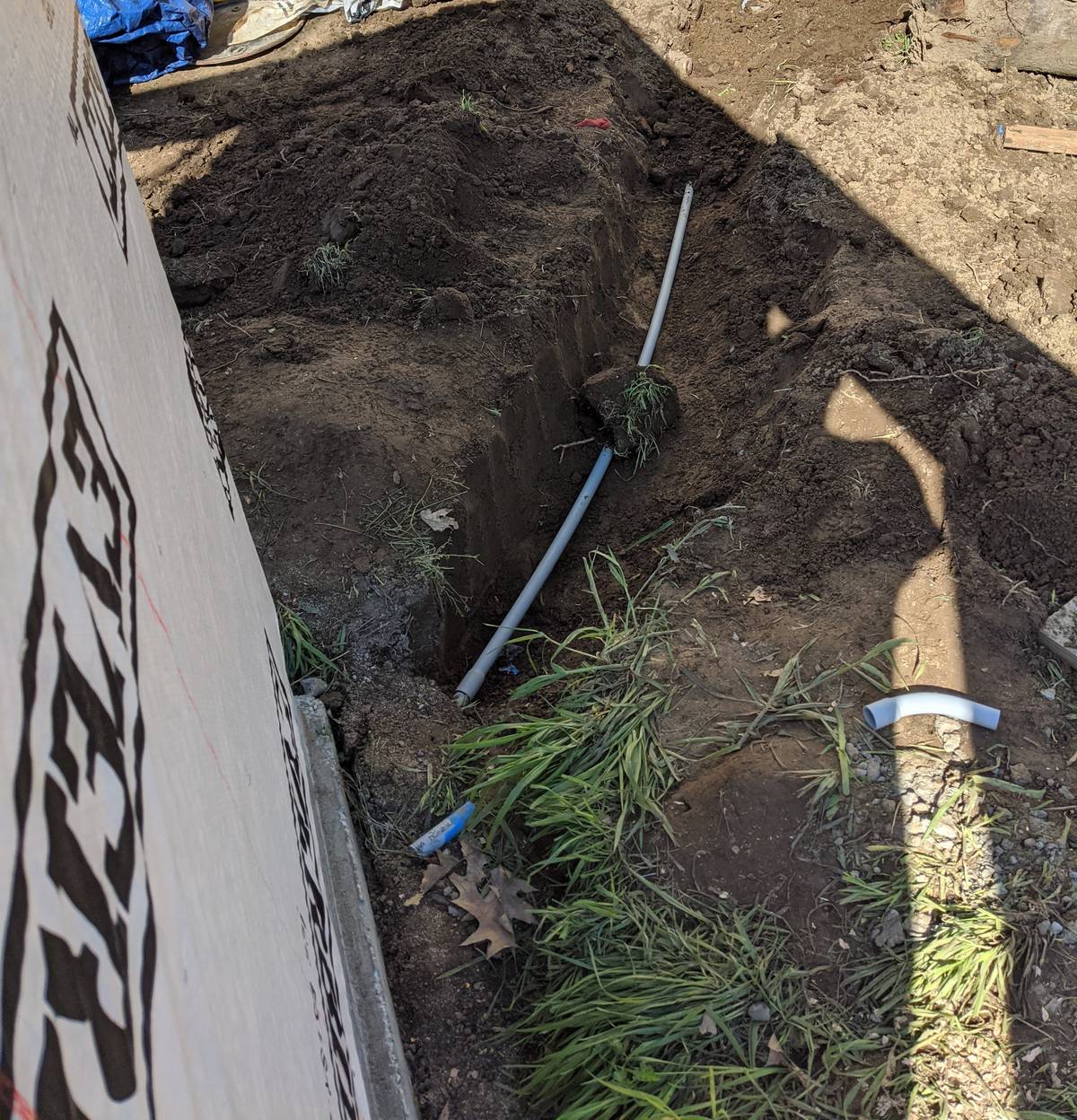 Utility trench excavated beside a new detached garage